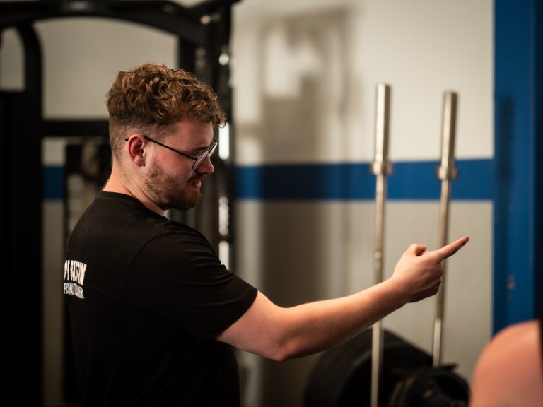 Weight loss coach Basingstoke working in a gym coaching clients