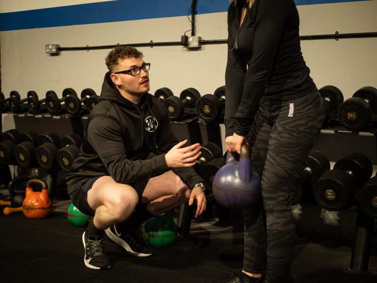 Basingstoke PT coaching client using a kettlebell