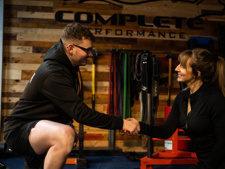 Personal trainer in Basingstoke shaking hands with a female client
